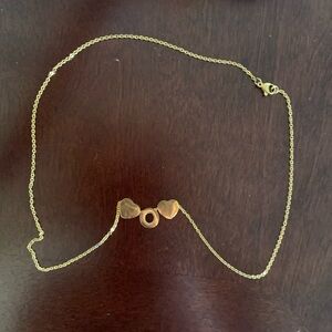 Gold toned O initial necklace with hearts